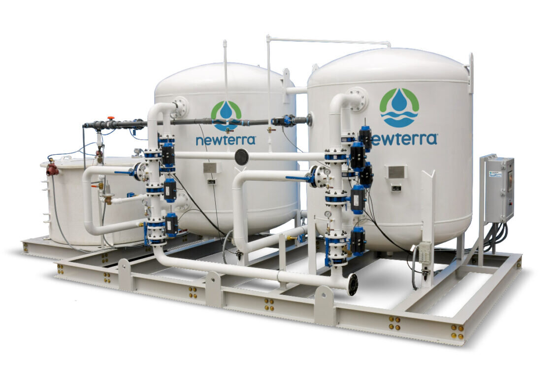 A product image with a white background of a Cochrane by Newterra water softening system consisting of a water tank connected to two elevated white vessels branded with Newterra logos, the entire system is supported by a metal frame and connected throughout with metal pipes with filters and components installed on the pipes, an electrical panel accompanies the unit