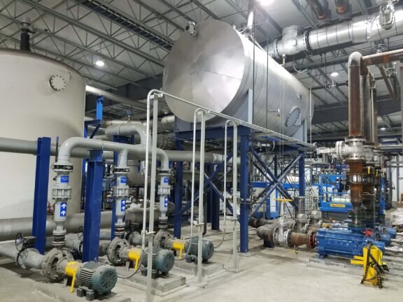 Industrial wastewater treatment system with an elevated tank and connected pipes