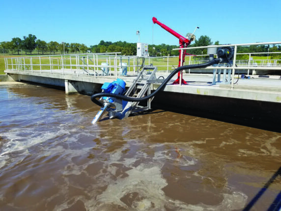 Stationary aerator treatment solution outdoors consisting of a rectangular holding pond protected by guard rails aerates water