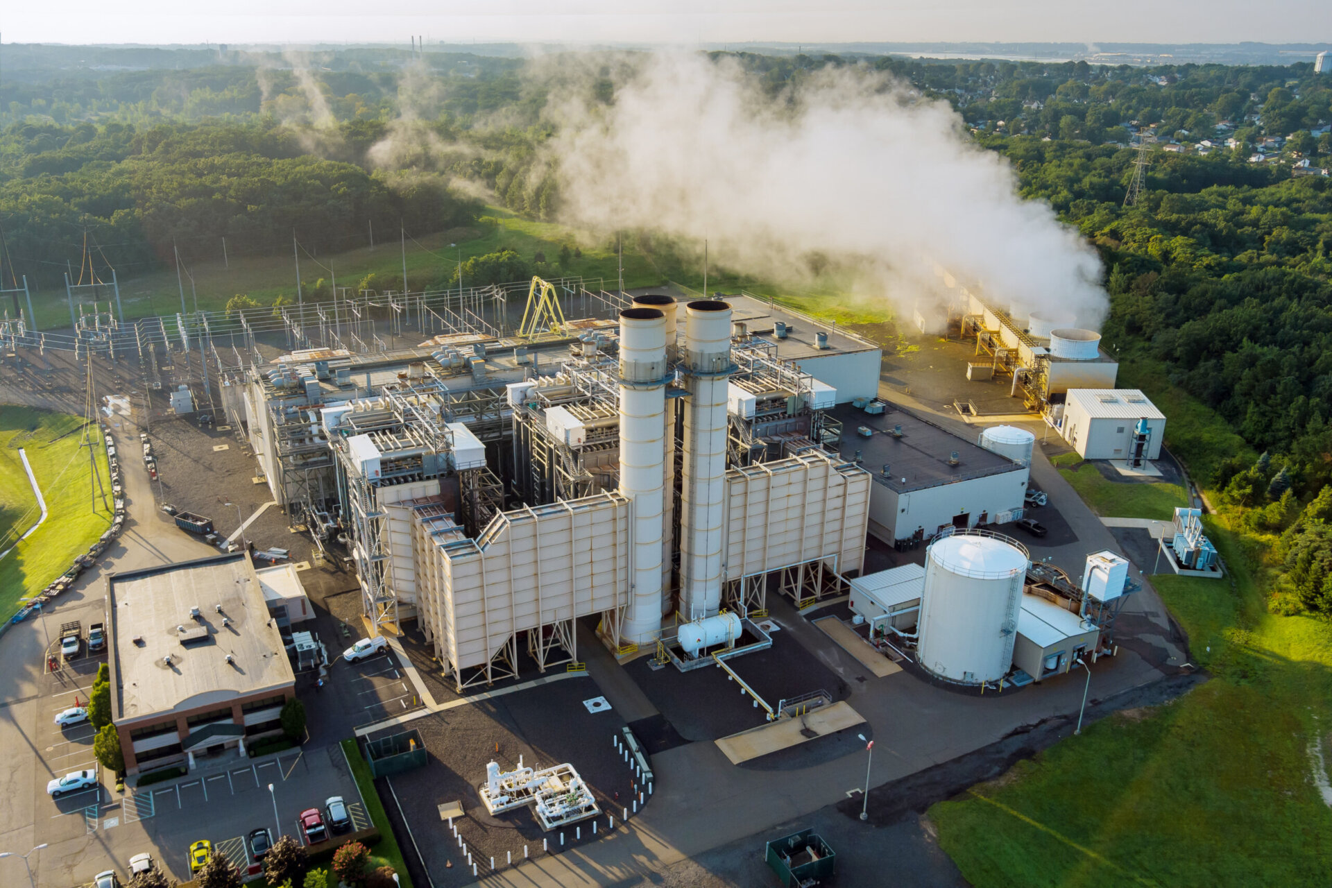 Energy thermal power station roof plant with white smoke cloud.