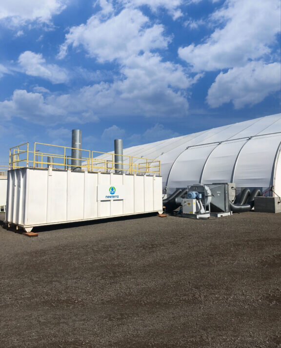 A Newterra Vapor Phase Vessel outside of a facility with a blue sky.