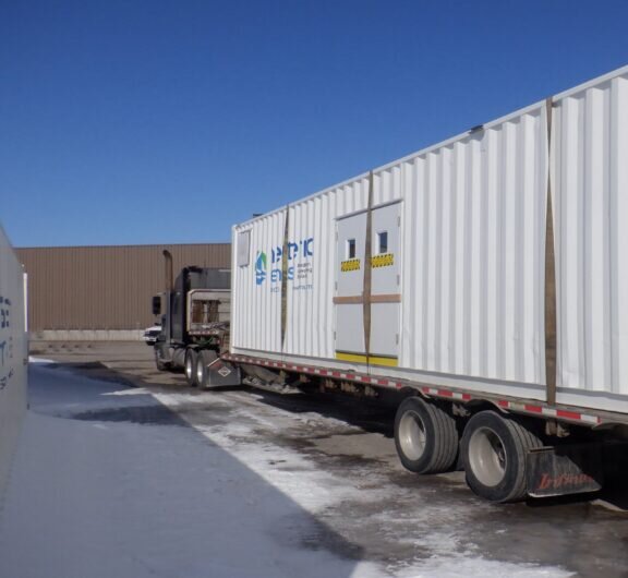 Newterra rentals truck parked outside of a warehouse