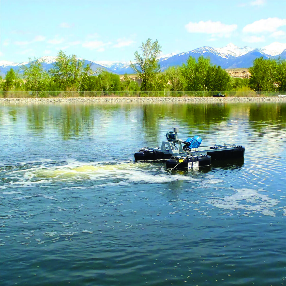 A Newterra Triton floating in a lagoon with green plants and mountains in the background