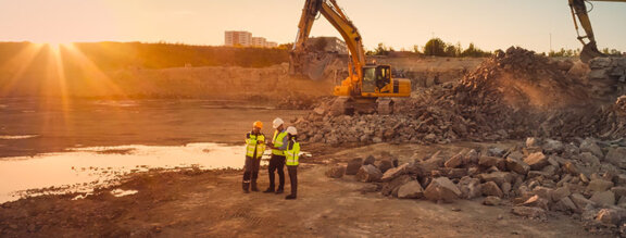 Developers and engineers meeting at a construction site of new homes development